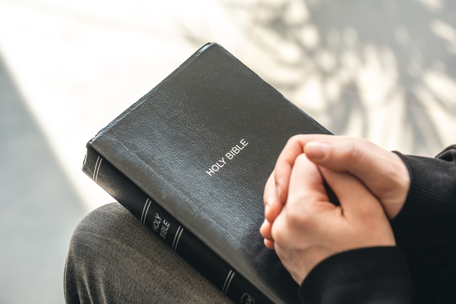 closeup-holy-bible-book-male-hands-min
